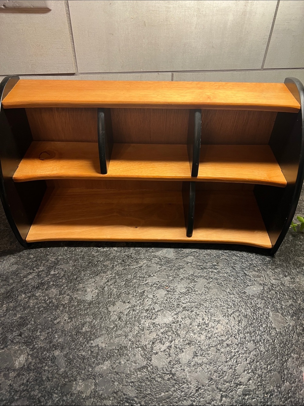 Black and wood tone wooden organizer. Assorted size bins. Sit on table or mount
